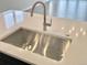 A modern sink with stainless steel bowl set in a quartz countertop kitchen island at 17569 Cerberus Ct, Monument, CO 80132