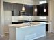 Stylish kitchen featuring stainless steel appliances, dark cabinetry, and a bright center island at 17569 Cerberus Ct, Monument, CO 80132
