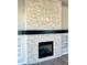 Bright living room featuring stone fireplace, hearth, and built-in shelves for stylish and practical living at 17569 Cerberus Ct, Monument, CO 80132