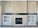 Bright living room featuring stone fireplace, hearth, and built-in shelves for stylish and practical living at 17569 Cerberus Ct, Monument, CO 80132
