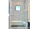 Tiled walk-in shower with glass door and rainfall showerhead for modern, luxurious living at 17569 Cerberus Ct, Monument, CO 80132