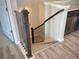 Staircase with a dark wood banister and carpeted stairs; luxury finishes throughout at 17569 Cerberus Ct, Monument, CO 80132