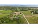 An aerial view shows a playground and walking paths in the lush, green community park with mountain views at 9869 Burberry Way, Highlands Ranch, CO 80129