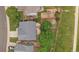 An aerial view shows a backyard with a patio and fire pit, a playground, and mature trees providing shade at 9869 Burberry Way, Highlands Ranch, CO 80129