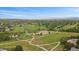 Expansive aerial view featuring a park with baseball field, winding pathways, and a playground in the distance at 9869 Burberry Way, Highlands Ranch, CO 80129