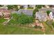 Wide aerial shot of the property shows mature trees and a large manicured lawn at 9869 Burberry Way, Highlands Ranch, CO 80129