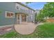 Spacious backyard patio with outdoor seating and lush landscaping and access to the house at 9869 Burberry Way, Highlands Ranch, CO 80129