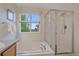 Bright bathroom features a soaking tub with shower and large window providing natural light at 9869 Burberry Way, Highlands Ranch, CO 80129