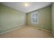 Cozy carpeted bedroom with pale green walls, neutral carpet, and a window with blinds at 9869 Burberry Way, Highlands Ranch, CO 80129