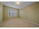 Bright carpeted bedroom features a window with blinds and neutral walls at 9869 Burberry Way, Highlands Ranch, CO 80129