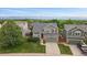 Charming two-story home with a well-manicured lawn, mature trees, and mountain views at 9869 Burberry Way, Highlands Ranch, CO 80129
