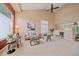 Bright living room with high ceilings, comfortable seating, and neutral color palette at 9869 Burberry Way, Highlands Ranch, CO 80129