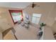 Spacious living room featuring a vaulted ceiling, large windows, and neutral decor at 9869 Burberry Way, Highlands Ranch, CO 80129