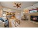 Cozy living room and kitchen offering an open floor plan, fireplace and comfortable seating at 9869 Burberry Way, Highlands Ranch, CO 80129