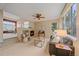 Open-concept living room features a fireplace and large windows, offering plenty of natural light at 9869 Burberry Way, Highlands Ranch, CO 80129