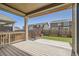 Relaxing covered deck and backyard features a privacy fence, artificial grass, raised garden boxes at 14952 Vienna Cir, Parker, CO 80134