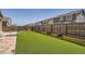 Backyard showcases green artificial grass, raised garden boxes, a privacy fence and several homes at 14952 Vienna Cir, Parker, CO 80134