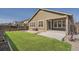 Backyard features green artificial grass, patio, raised garden boxes, a privacy fence and a home's exterior at 14952 Vienna Cir, Parker, CO 80134