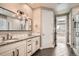 Bathroom featuring double sinks and a modern lighting fixture at 14952 Vienna Cir, Parker, CO 80134