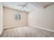 Bright bedroom features neutral paint, carpet flooring, a ceiling fan and a large window with blinds at 14952 Vienna Cir, Parker, CO 80134