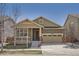 Charming single-Gathering home featuring a manicured front yard and an attached two-car garage at 14952 Vienna Cir, Parker, CO 80134