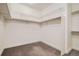 Walk-in closet featuring wall-mounted shelving and carpet floors at 14952 Vienna Cir, Parker, CO 80134