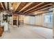 Unfinished basement with exposed ceiling beams, window and concrete floors at 15800 E 121St Ave # 3J, Brighton, CO 80603