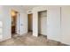 Bright bedroom with neutral carpeting, double-door closet, and access to a full bathroom at 15800 E 121St Ave # 3J, Brighton, CO 80603