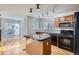 Kitchen with oak cabinets, granite island, and black appliances at 15800 E 121St Ave # 3J, Brighton, CO 80603