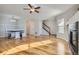 Bright living room with hardwood floors, a fireplace, and built-in bench seating at 15800 E 121St Ave # 3J, Brighton, CO 80603