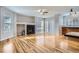 Open living room and kitchen with hardwood floors and a fireplace at 15800 E 121St Ave # 3J, Brighton, CO 80603