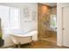 Bright bathroom featuring free-standing tub and walk-in shower at 740 Deer Clover Cir, Castle Pines, CO 80108