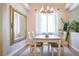 Elegant dining room with hardwood floors, a statement mirror, and ample natural light perfect for gatherings at 740 Deer Clover Cir, Castle Pines, CO 80108