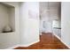 Hallway with hardwood floors and white trim showcasing architectural details at 740 Deer Clover Cir, Castle Pines, CO 80108