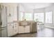 Modern kitchen featuring stainless steel appliances, white cabinetry, and a farmhouse sink with a view at 740 Deer Clover Cir, Castle Pines, CO 80108