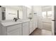 Bathroom showcasing double sink vanity, black hardware, and access to the bedroom at 5785 N Jericho Way, Aurora, CO 80019
