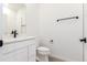 Bright bathroom featuring white cabinets, modern fixtures, and neutral tiling with an updated design at 5785 N Jericho Way, Aurora, CO 80019