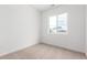 Bedroom featuring neutral carpet, white walls, and natural light from a window at 5785 N Jericho Way, Aurora, CO 80019