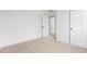 Bedroom featuring neutral carpet, white walls, and access to the closet at 5785 N Jericho Way, Aurora, CO 80019