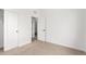 Clean bedroom featuring neutral carpet, white walls, and access to the bathroom at 5785 N Jericho Way, Aurora, CO 80019