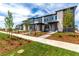 Attractive townhome exterior showcasing modern design elements, well-kept landscaping, and inviting entrances at 5785 N Jericho Way, Aurora, CO 80019