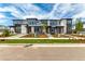 Modern townhome complex with appealing exteriors, landscaping, sidewalks, and easy street access at 5785 N Jericho Way, Aurora, CO 80019