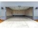 Spacious attached garage with ample room for vehicles and storage, and an access door at 5785 N Jericho Way, Aurora, CO 80019