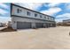 Row of townhome garages showcases gray doors, gray siding and easy access to residences at 5785 N Jericho Way, Aurora, CO 80019