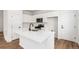 Modern kitchen featuring white cabinets, stainless steel appliances, quartz countertops, and a stylish island at 5785 N Jericho Way, Aurora, CO 80019