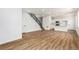 Spacious living room and kitchen combo with wood floors, staircase and white cabinets and countertops at 5785 N Jericho Way, Aurora, CO 80019