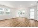 Bright, open living room with wood floors, recessed lighting, and multiple windows offering ample natural light at 5785 N Jericho Way, Aurora, CO 80019
