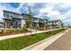 Street view of modern townhomes with well-maintained landscaping, sidewalks, and inviting entryways at 5785 N Jericho Way, Aurora, CO 80019