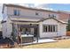 Backyard featuring a covered patio, hot tub, and large windows at 11025 Watermark St, Parker, CO 80134
