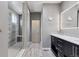 Modern bathroom with dual sinks, glass shower, and neutral color scheme at 11025 Watermark St, Parker, CO 80134